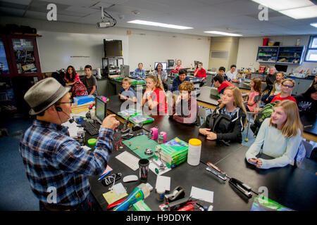 An Asian American science teacher lectures an attentive middle school STEM (Science, Technology, Engineering and Math) class in Mission Viejo, CA. Stock Photo