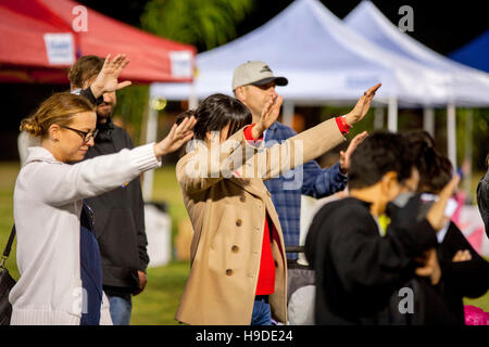 The multiracial faithful gather in Mission Viejo, CA, for an nighttime open air prayer service as part of The National Day of Prayer, an annual day of observance held on the first Thursday of May, designated by the United States Congress, when people are Stock Photo