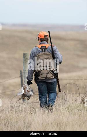 A hunter with Hungarian Partridge Stock Photo