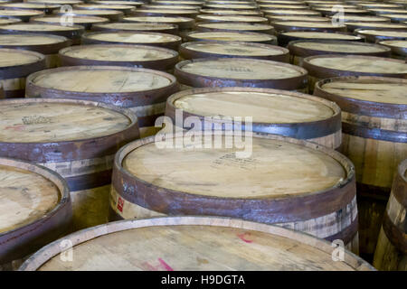 Used oak barrels in bottling facility of Kentucky distillery. Stock Photo