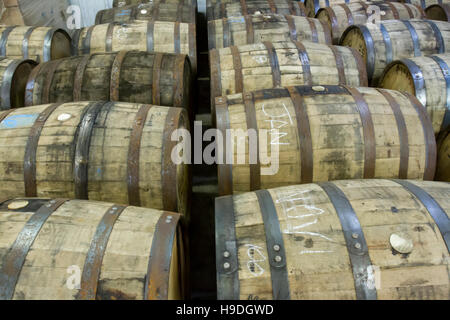 Used oak barrels in bottling facility of Kentucky distillery. Stock Photo