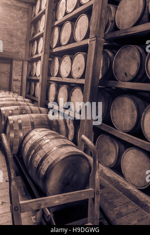 Oak barrels aging inside  Rik house in vintage tones. Stock Photo