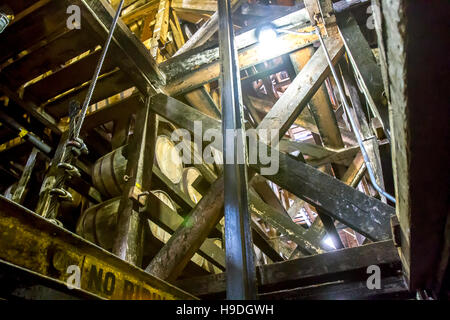 Oak barrels aging inside wooden RIk or rack house in bourbon distillery. Stock Photo