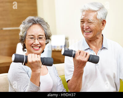 happy senior couple exercising using dumbbells, happy and smiling Stock Photo