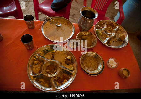 Dirty Dishes on Table after Meal  in restaurant  at Camel Fair in Pushkar  Rajasthan  India Stock Photo