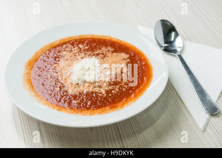 Tomato soup with shredded parmesan cheese on top Stock Photo