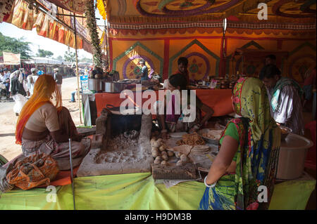 Women preparing Traditional Rajasthani food dal-bati roti chpati in ...