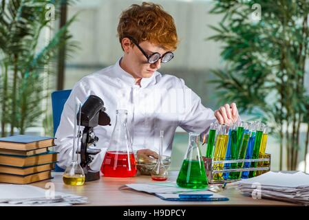 Young crazy chemist working in the lab Stock Photo