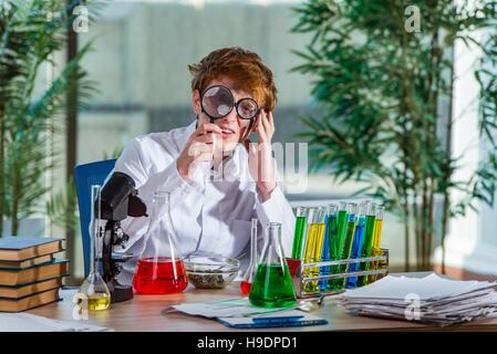 Young crazy chemist working in the lab Stock Photo