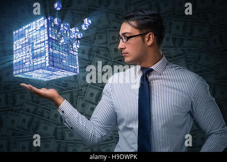 Businessman holding financial cube in business concept Stock Photo