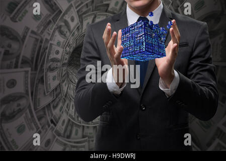 Businessman holding financial cube in business concept Stock Photo