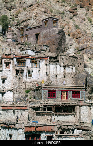 The plum coloured Hemis Gompa sitting above a collage of stone grey and white village houses in the Ladakh capital of Leh Stock Photo