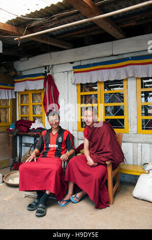 Two novice monks sitting in front of their room in Tawang Monastery in Tawang, India. Stock Photo