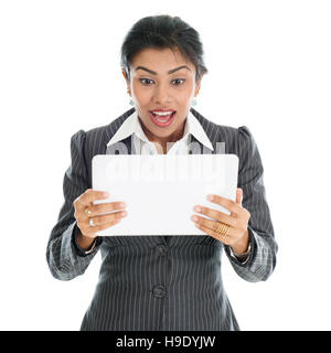 Black business woman using tablet pc and getting shocked, isolated on white background. Stock Photo