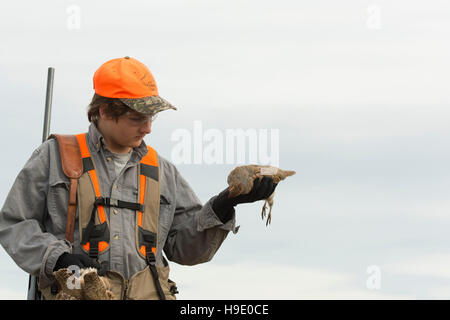 A hunter with Hungarian Partridge Stock Photo