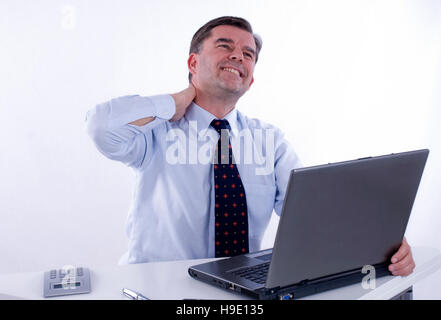 Tense businessman, over 50, at work Stock Photo