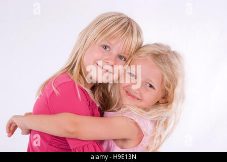 Two happy, blonde girls hugging Stock Photo