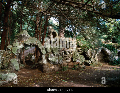 Remains of a C19th rockwork 'ruined castle' built of tufa by Head Gardener William Barron on the N side of Elvaston Castle lake, Derbyshire. Stock Photo