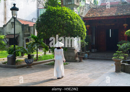 Woman in ao dai dress at Quan Thanh Temple, Hanoi, Vietnam Stock Photo