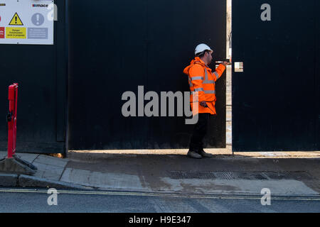 Groundsmen construction site workers in high visibility jackets on a building site, london Stock Photo