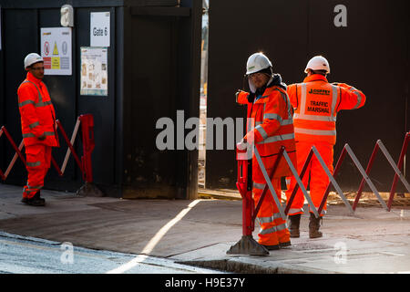 Groundsmen construction site workers in high visibility jackets on a building site, london Stock Photo