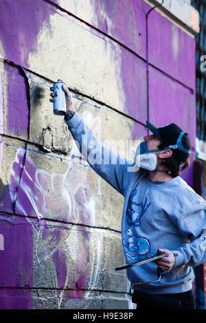 Graffiti artist`s at work with spray paint cans Stock Photo - Alamy