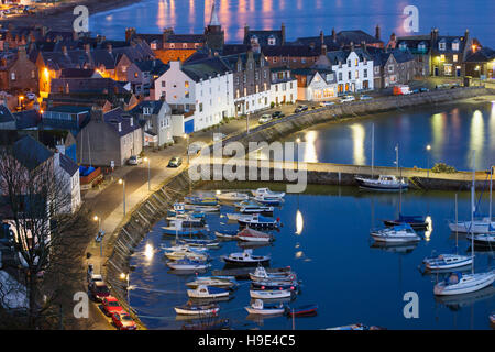 The Scottish town seaside town: north-east coastal seafront buildings of Stonehaven bay, with natural harbour moorings, boats at anchor and promenade at dawn, Aberdeenshire, UK