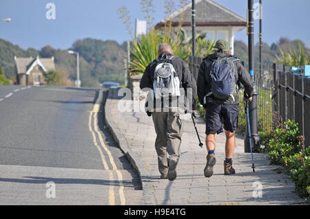Two men walking along the seafront in Falmouth, Cornwall Stock Photo
