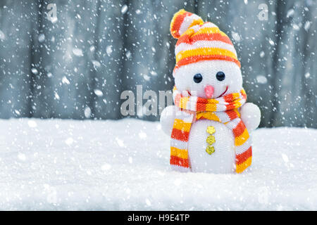 Cute frost ice snowman in winter snow background. Christmas theme