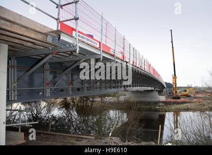 A new steel and concrete road bride being constructed over a river near Birmingham, UK. Viewed from below showing temporary support for concrete Stock Photo