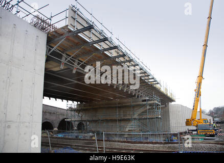 A new steel and concrete road bride being constructed over a railway. Viewed from below showing temporary support for concrete Stock Photo