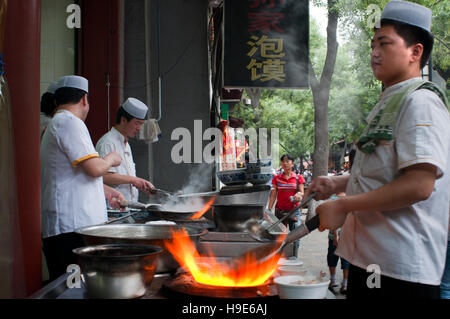 Muslim quarter of Xian, Shaanxi, China, Asia. Silk road, Huimin Street, Beiyuanmen Moslem market. Cooking in the street. Stock Photo