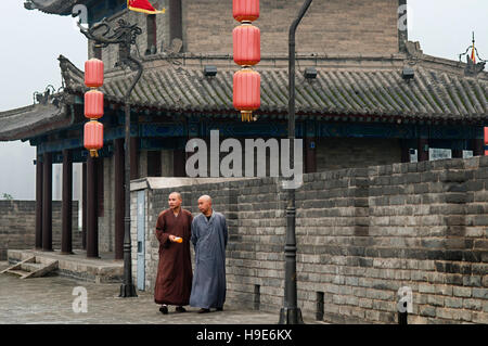 Monks walking in the ancient Xian City Wall Gate and Tower, Shaanxi, China Stock Photo