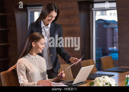 Two female colleagues discussing their project Stock Photo