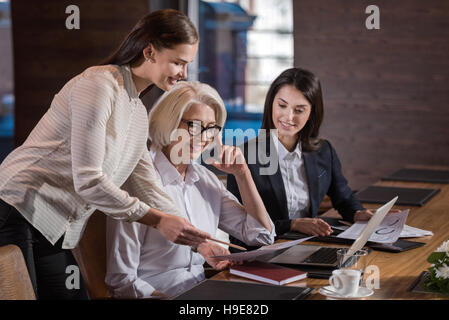 Young colleagues discussing the project with their boss Stock Photo