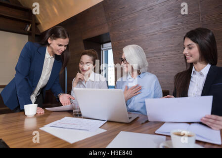 Joyful colleagues working on project together Stock Photo