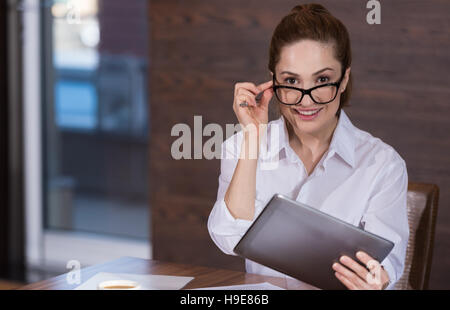 Joyful woman wearing glasses in an office Stock Photo