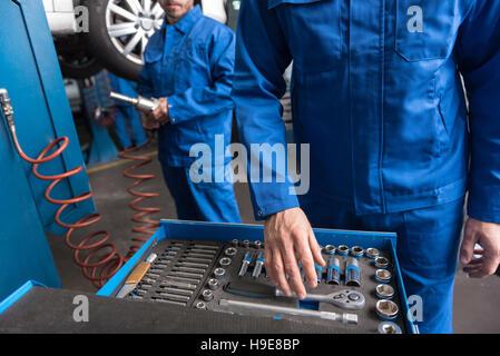 Set mechanical tools. Professional car mechanic using different tools for  working in auto repair service Stock Photo - Alamy