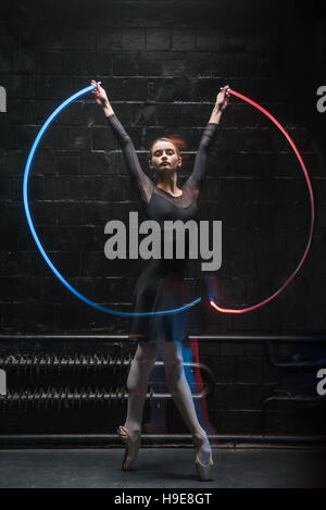 Charismatic ballet dancer dancing with a colorful gymnastic ribbon Stock Photo