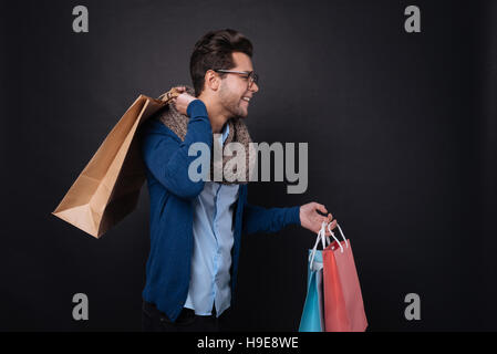 Positive man enjoying shopping