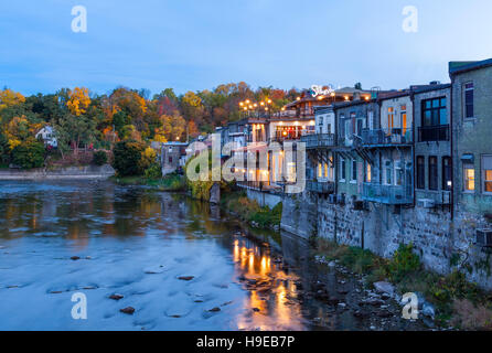 The Grand River and the back of buildings that run along Grand River Street at dusk in Paris, Brant County, Ontario, Canada. Stock Photo