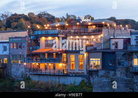 The back of buildings that run along Grand River Street at dusk in Paris, Brant County, Ontario, Canada. Stock Photo