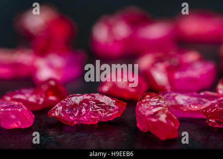 Collection of deep red uncut ruby crystals on dark background. Stock Photo
