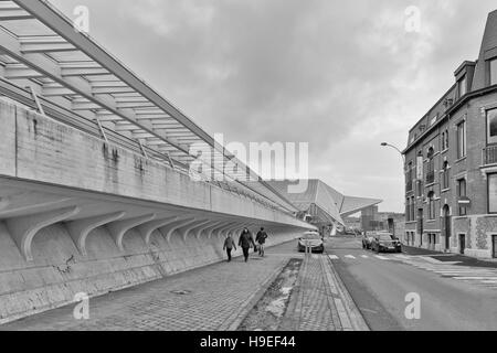 LIEGE, BELGIUM - December 2014: Traveller walking in front of the Liege-Guillemins railway station, designed by Santiago Calatrava. Black and white ph Stock Photo