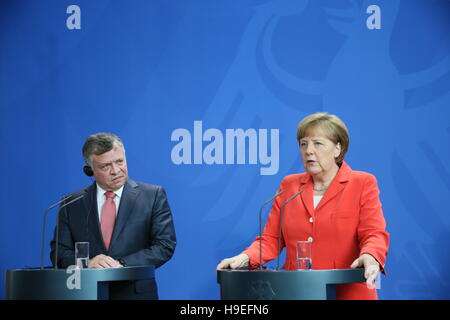 King of Jordan Abdullah II gives joint press statement with Chancellor Merkel on May, 13th 2015 in Berlin, Germany. Stock Photo