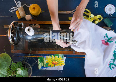 Hands of Caucasian woman using sewing machine Stock Photo