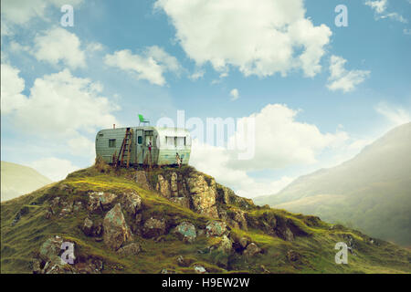 Motor home on hill in green landscape Stock Photo