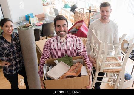Smiling friends moving house Stock Photo