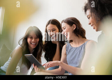 Smiling women using digital tablet Stock Photo