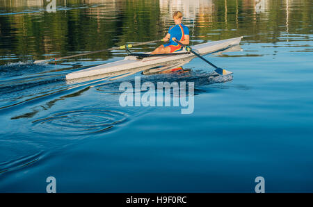 Caucasian man rowing on river Stock Photo